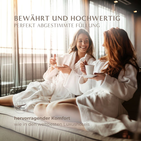 Zwei Frauen genießen entspannten Komfort mit einer hochwertigen Natural Hybrid Bettdecke im luxuriösen Ambiente